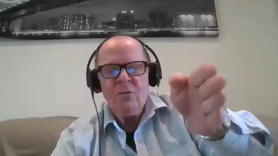 Rick Collingwood wearing headphones and glasses, speaking on a Zoom call