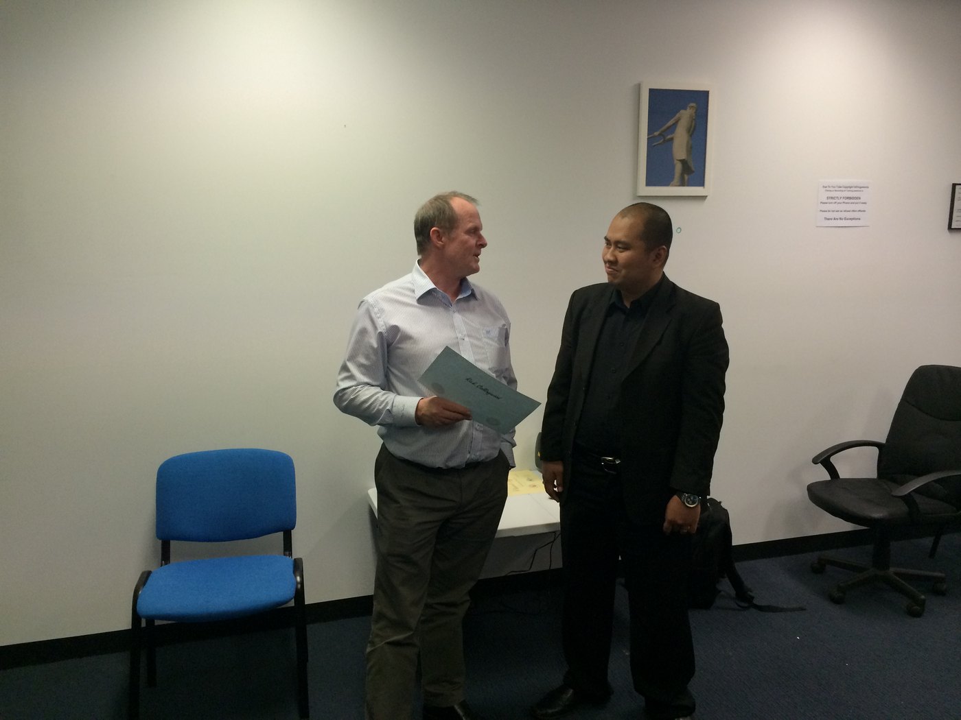 Rick Collingwood receiving a certificate from Dodie Magis, Javanese magnetism.