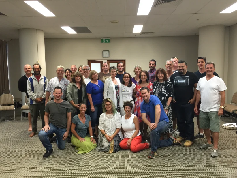 A Global Hypnosis Academy class photographed together in the training room