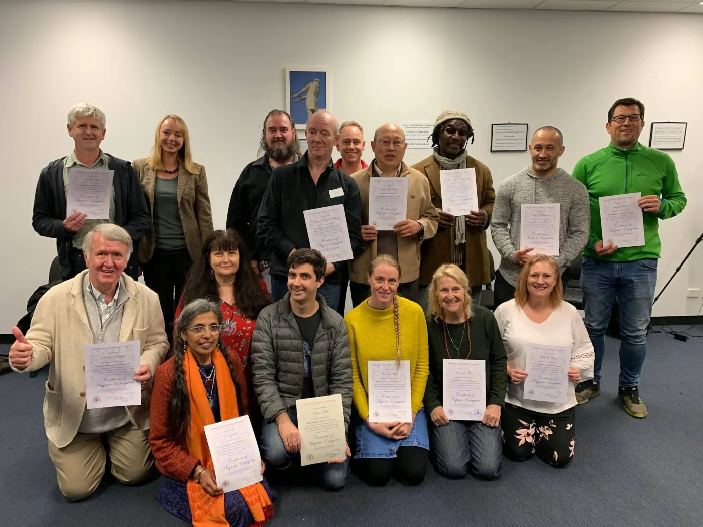 A Global Hypnosis Academy class holding their certificates at the end of their training